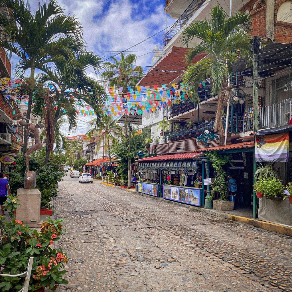 colorful flags and cobblestone streets in Zona Romantica